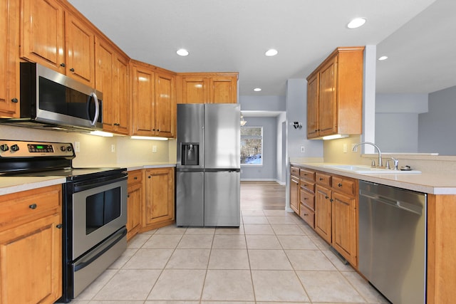 kitchen featuring appliances with stainless steel finishes, light tile patterned floors, and sink