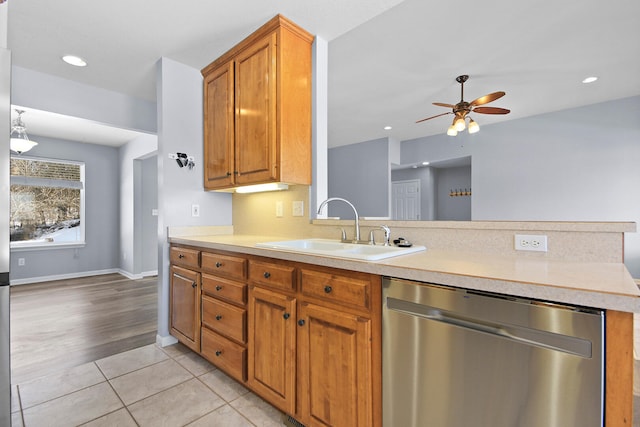 kitchen with stainless steel dishwasher, ceiling fan, light tile patterned flooring, and sink