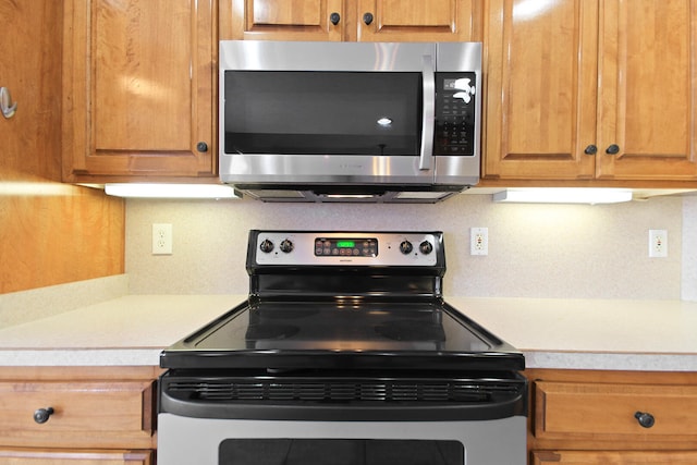 kitchen featuring stainless steel appliances and decorative backsplash