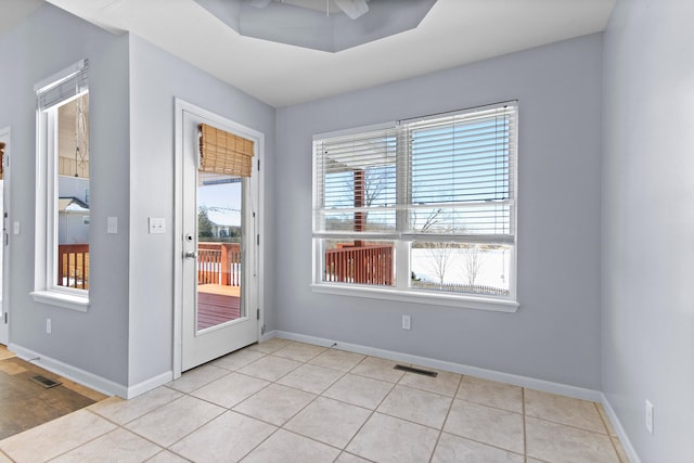 interior space with light tile patterned floors and a healthy amount of sunlight