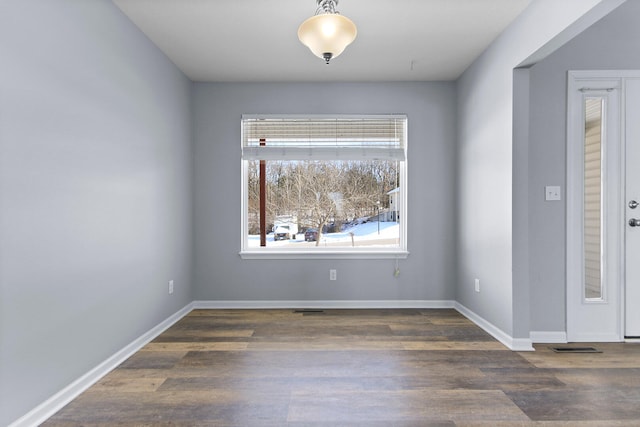 spare room featuring dark hardwood / wood-style flooring