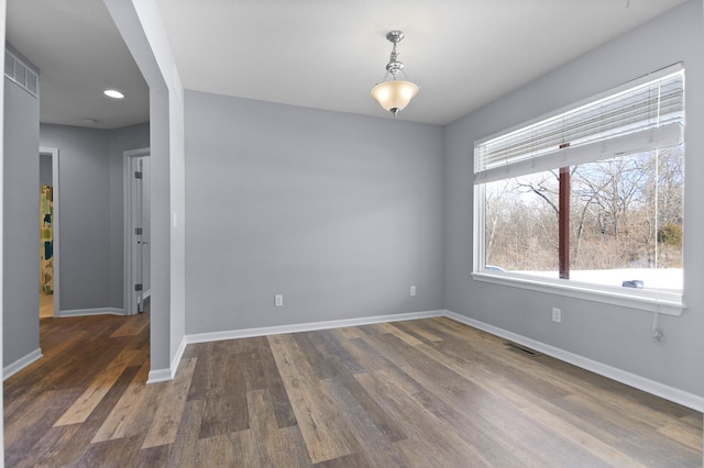 unfurnished room with dark hardwood / wood-style flooring