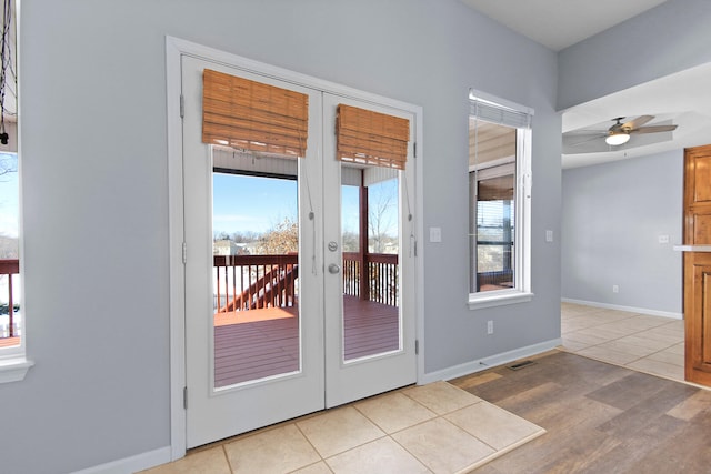 entryway with french doors, light tile patterned flooring, and ceiling fan