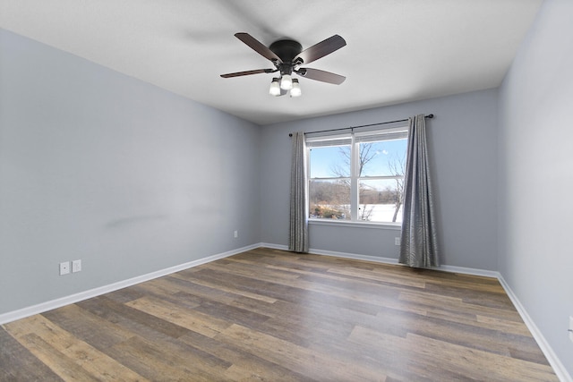 empty room featuring ceiling fan and dark wood-type flooring