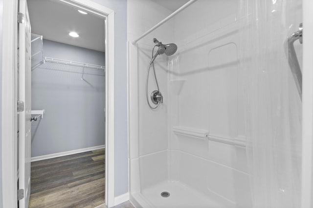 bathroom with hardwood / wood-style floors and a shower