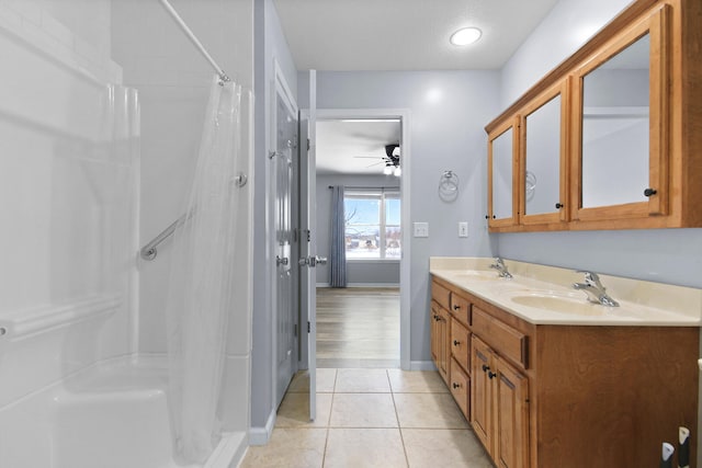 bathroom with tile patterned flooring, ceiling fan, a shower with shower curtain, and vanity