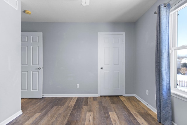 empty room featuring dark hardwood / wood-style flooring