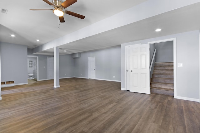 basement with ceiling fan and dark hardwood / wood-style flooring