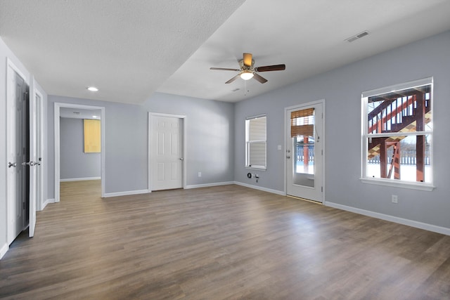 spare room with a textured ceiling, hardwood / wood-style floors, and ceiling fan