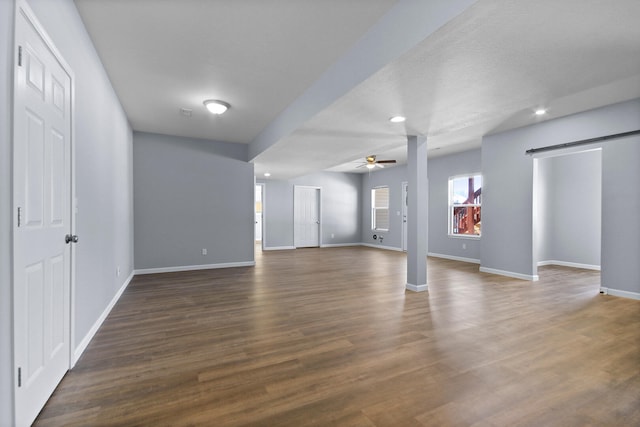 interior space with ceiling fan, dark wood-type flooring, and a textured ceiling