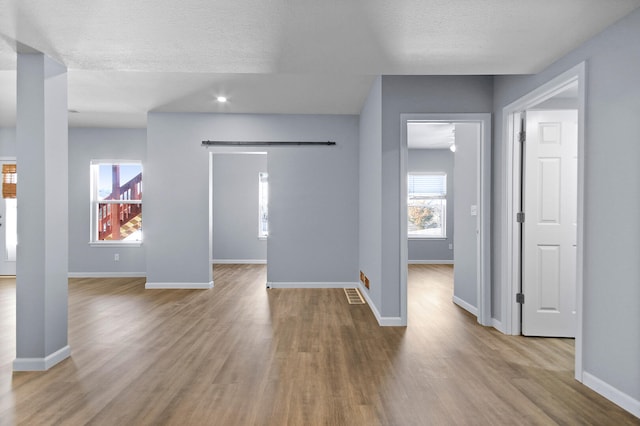 interior space with a textured ceiling and light wood-type flooring