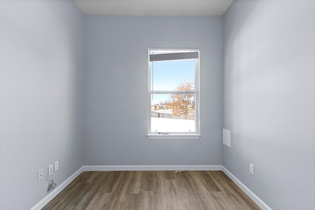 unfurnished room with dark hardwood / wood-style floors