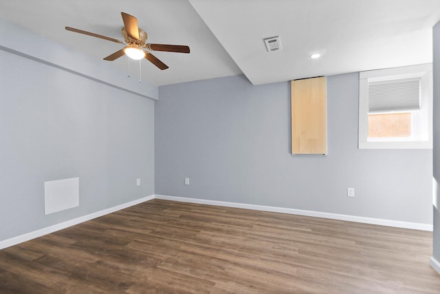 unfurnished room with ceiling fan and dark hardwood / wood-style flooring