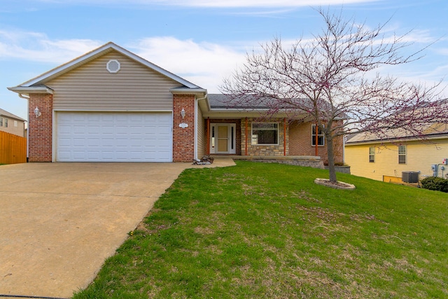 3103 Woods Crossing Dr, Columbia, MO 65202 - ranch-style home featuring central AC unit, driveway, a front lawn, and brick siding