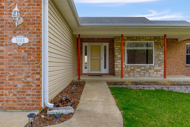 3103 Woods Crossing Dr, Columbia, MO 65202 - view of exterior entry featuring a shingled roof, covered porch, and brick siding
