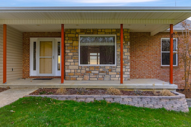 3103 Woods Crossing Dr, Columbia, MO 65202 - view of exterior entry featuring stone siding, brick siding, and a porch