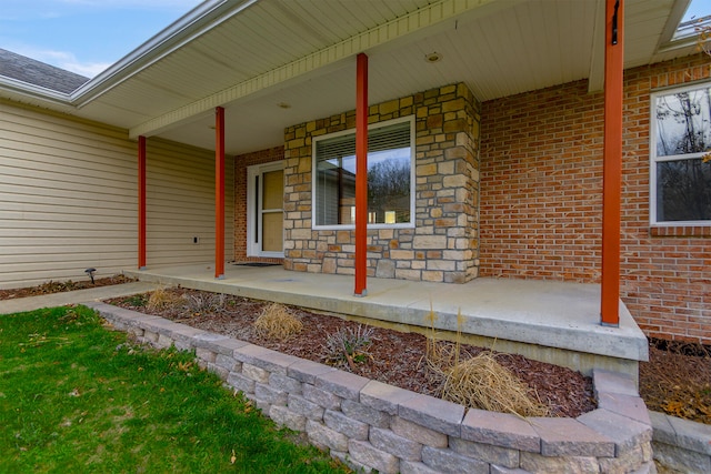 3103 Woods Crossing Dr, Columbia, MO 65202 - entrance to property featuring covered porch, stone siding, and brick siding