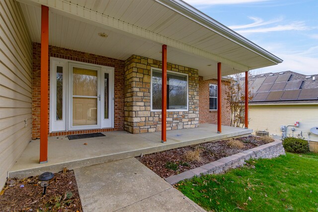 3103 Woods Crossing Dr, Columbia, MO 65202 - doorway to property featuring stone siding, brick siding, and a porch