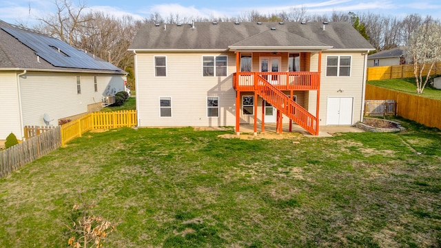 3103 Woods Crossing Dr, Columbia, MO 65202 - rear view of house with a lawn, a wooden deck, stairway, and a fenced backyard