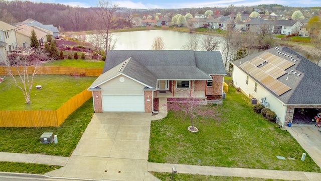 3103 Woods Crossing Dr, Columbia, MO 65202 - view of front of house featuring fence, a front yard, brick siding, a residential view, and driveway