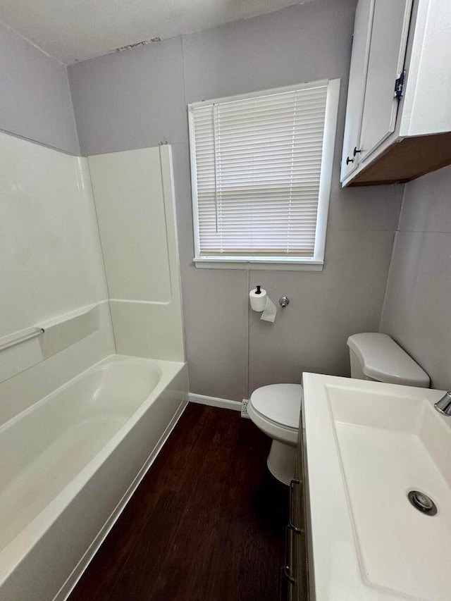 full bathroom featuring toilet, baseboards, wood finished floors, and vanity