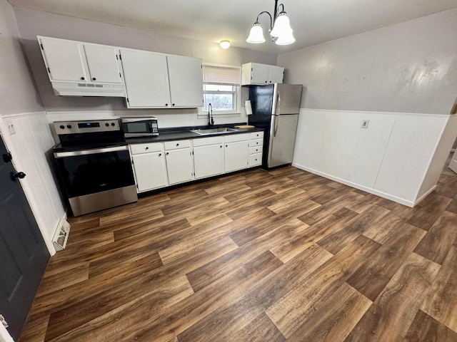 kitchen with a notable chandelier, decorative light fixtures, white cabinetry, and stainless steel appliances