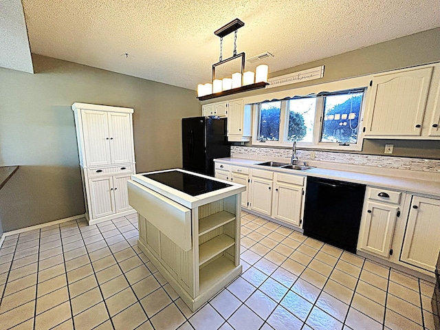 kitchen featuring a sink, black appliances, a center island, and light tile patterned floors