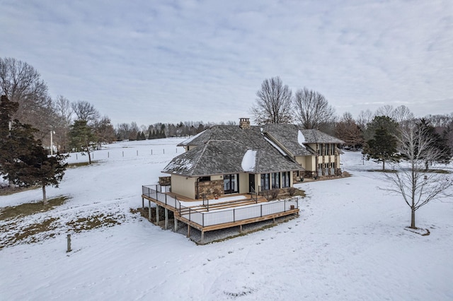 snow covered property featuring a wooden deck