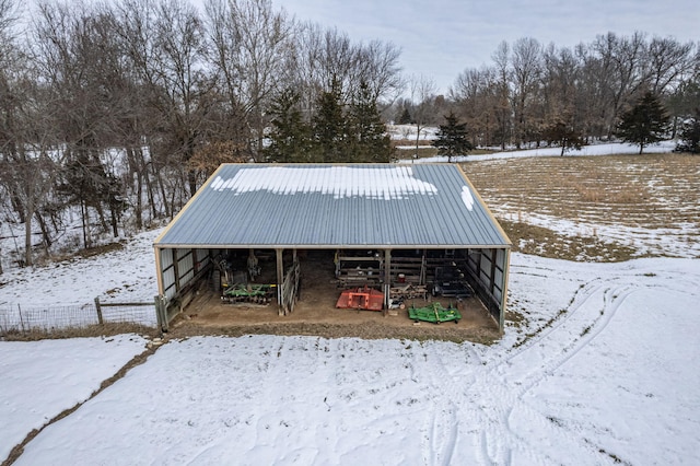 yard covered in snow with an outbuilding