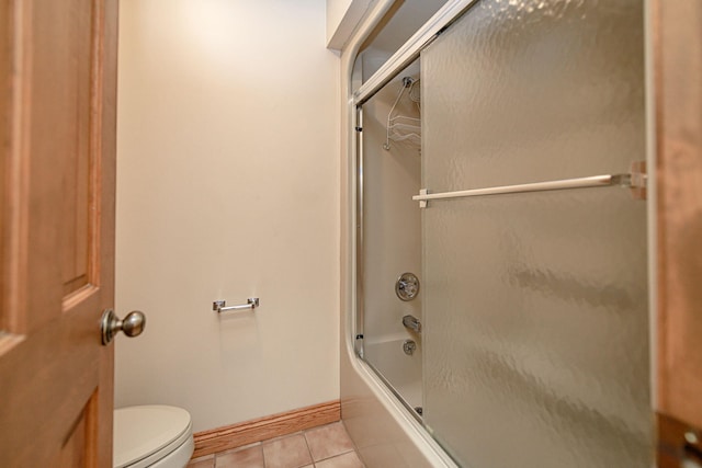 bathroom featuring shower / bath combination with glass door, toilet, and tile patterned flooring