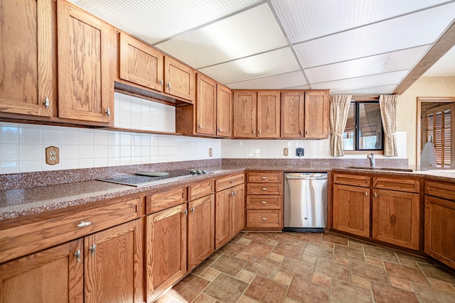 kitchen with cooktop, dishwasher, tasteful backsplash, and sink