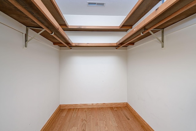 spacious closet featuring light wood-type flooring