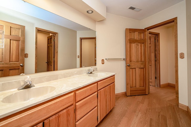 bathroom with hardwood / wood-style floors and vanity