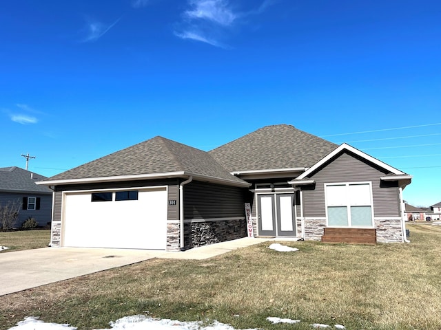 view of front of property with a garage and a front lawn