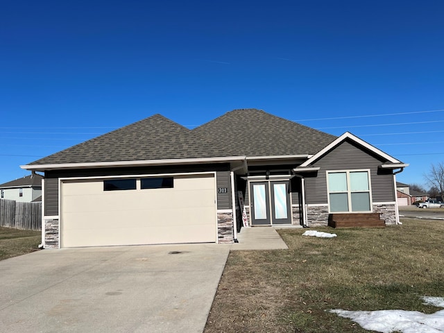 view of front of property with a garage and a front yard