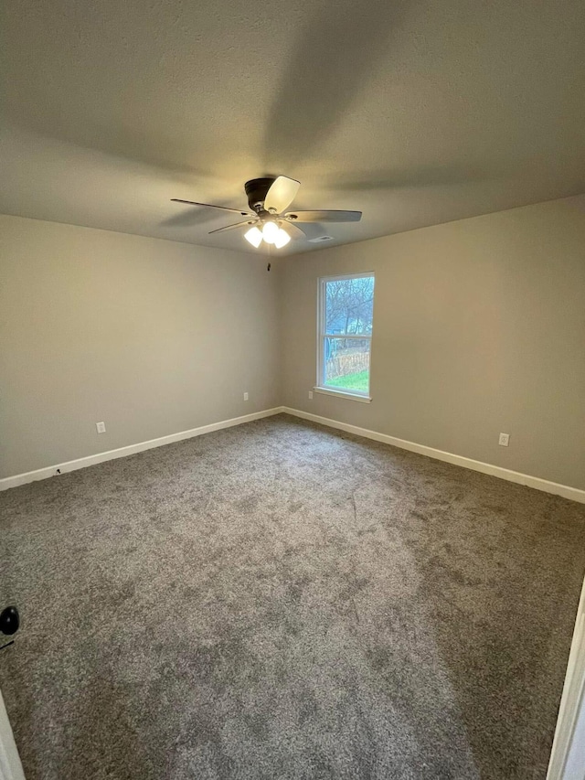 empty room featuring ceiling fan and carpet floors