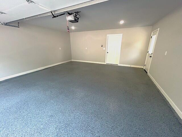 908 7th St, Boonville, MO 65233 - garage featuring baseboards and a garage door opener