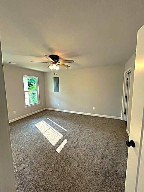 908 7th St, Boonville, MO 65233 - spare room with dark colored carpet, baseboards, and a ceiling fan