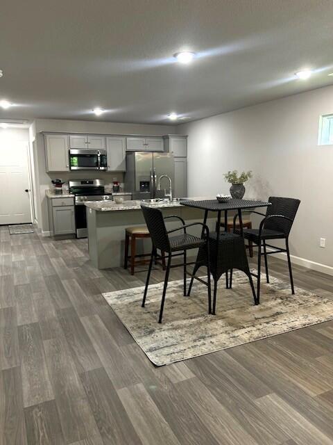 908 7th St, Boonville, MO 65233 - dining area with dark wood-style flooring, baseboards, and recessed lighting