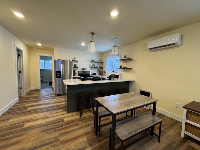 dining area with a healthy amount of sunlight, a wall mounted AC, and dark wood-type flooring