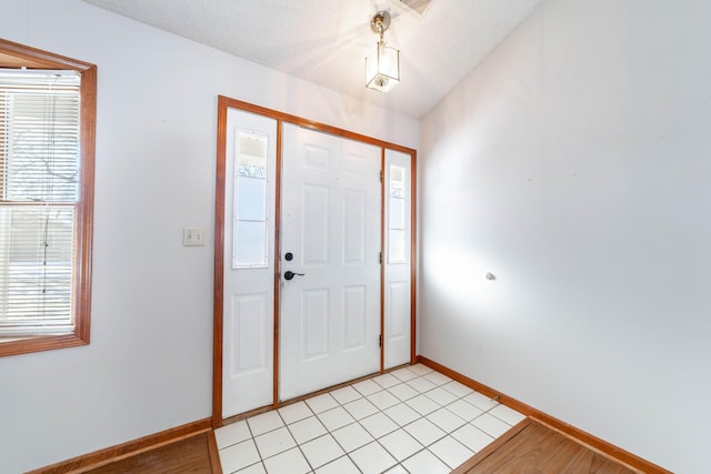 foyer entrance featuring a textured ceiling and light hardwood / wood-style floors