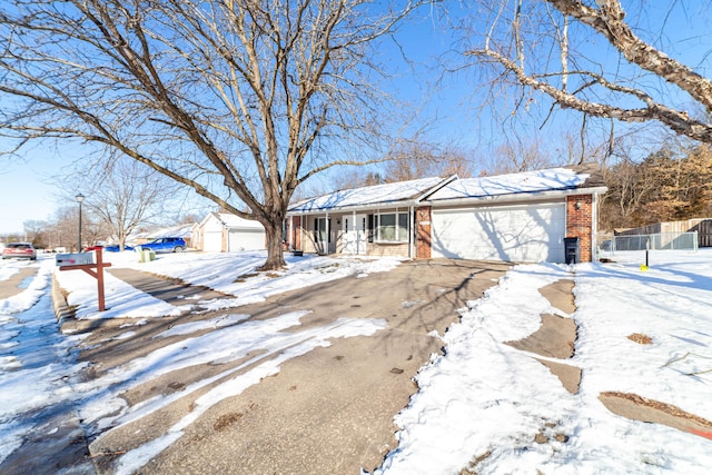 ranch-style home with covered porch and a garage