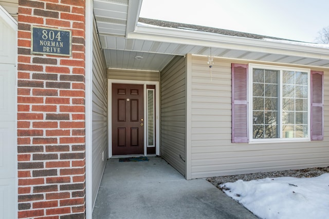 view of snow covered property entrance