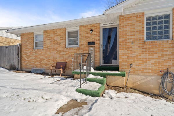 view of snow covered property entrance