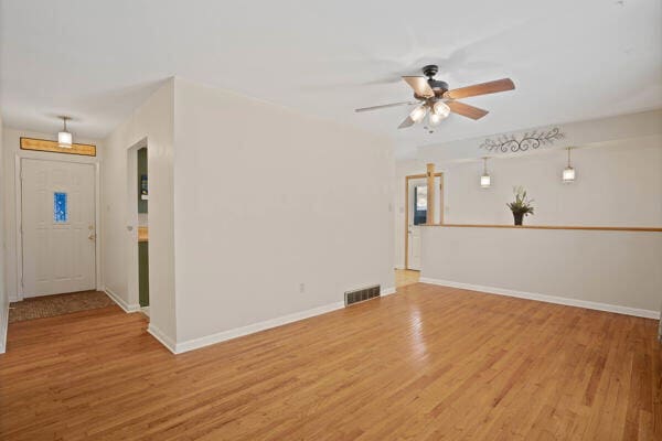 unfurnished room with ceiling fan and wood-type flooring