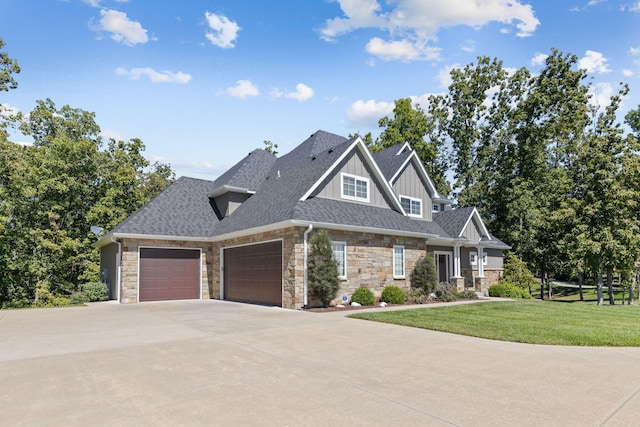 craftsman-style home featuring a garage and a front lawn