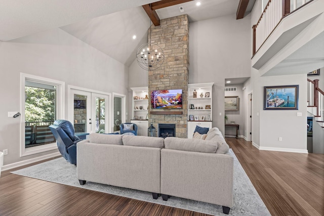 living room featuring french doors, an inviting chandelier, a stone fireplace, beamed ceiling, and dark hardwood / wood-style floors