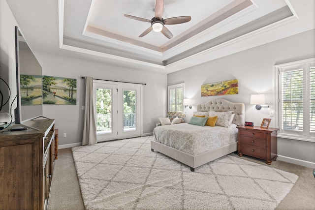 bedroom featuring access to outside, crown molding, ceiling fan, a tray ceiling, and light colored carpet