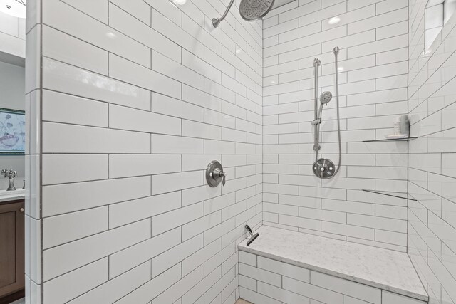 bathroom with sink and tiled shower