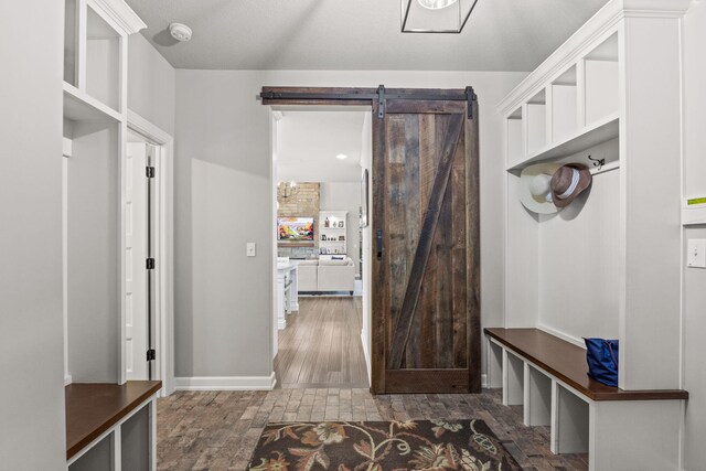 mudroom featuring dark hardwood / wood-style flooring and a barn door